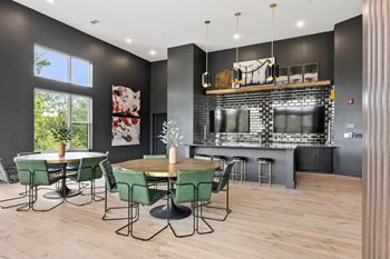 A modern dining room with a bar area and a television.